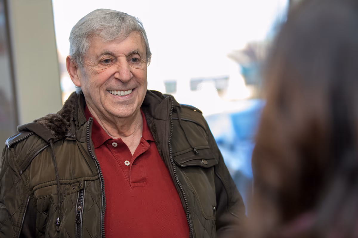 Full-arch implant prosthesis held in gloved hands