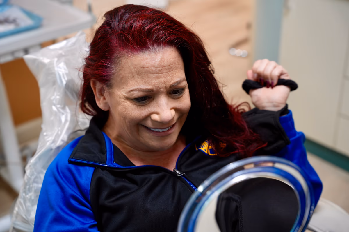 Patient reacting to her smile transformation in the treatment room