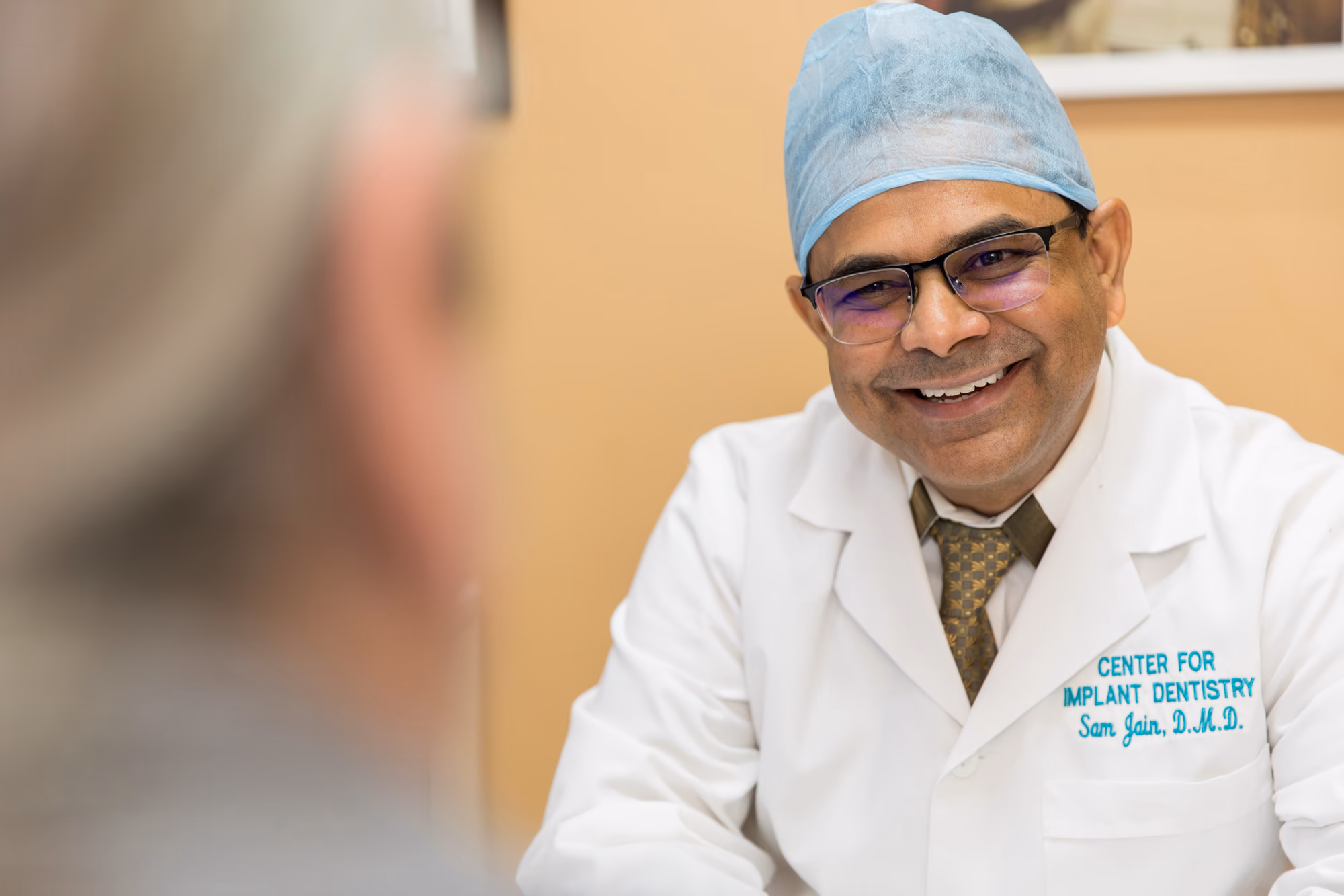 Patient smiling after full-mouth dental implant treatment