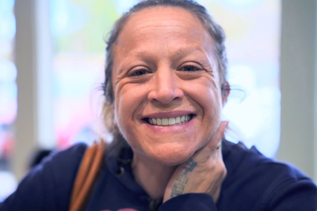 Patient smiling after implant dentistry treatment